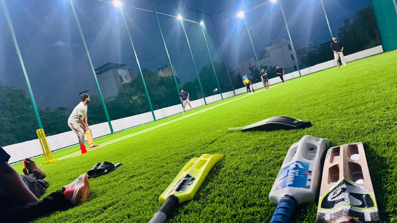 Cricket gear ready beside an active night match