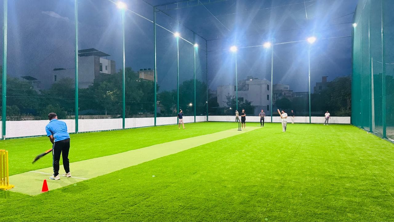 Players enjoying box cricket under floodlights at Boundary 150