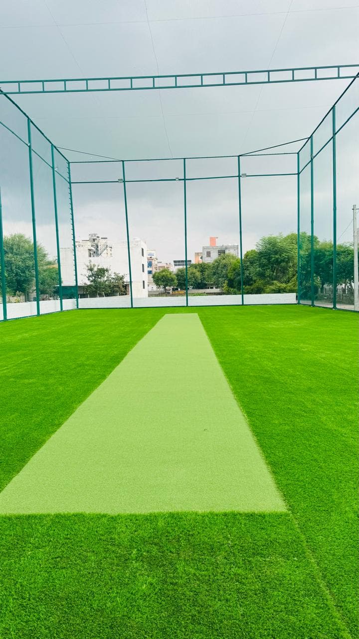 The central cricket pitch across Boundary 150's green turf